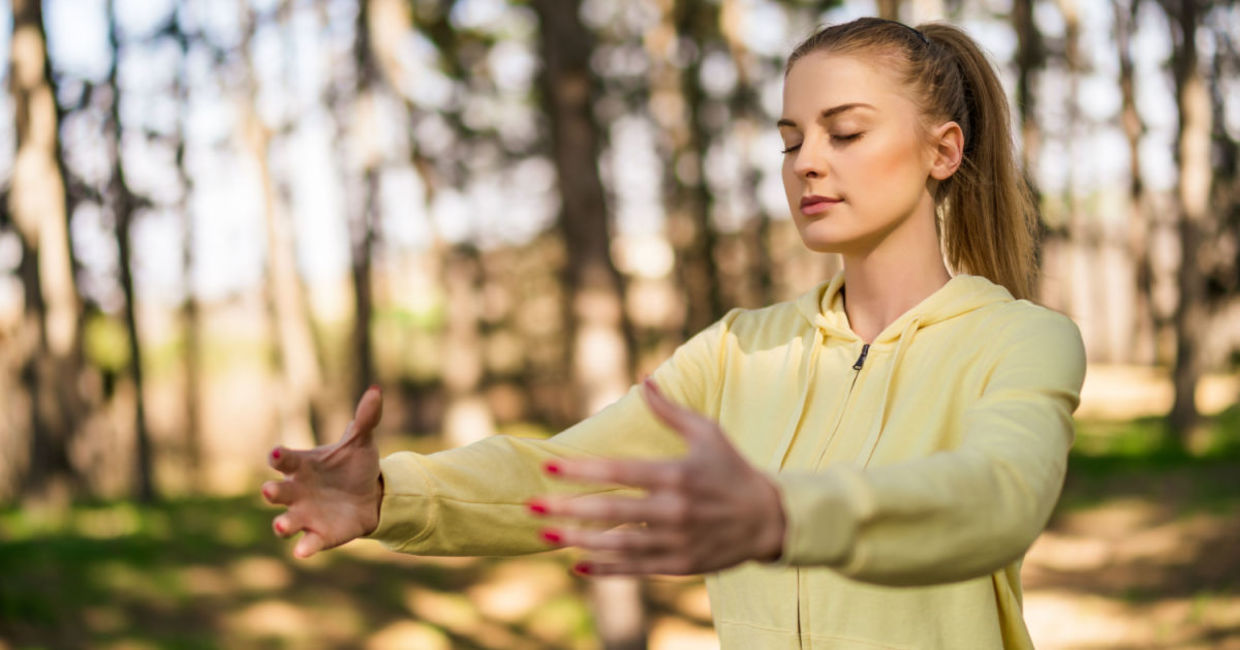 Practicing tai chi in a forest.
