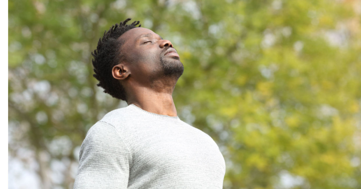 Man doing a deep breathing exercise.