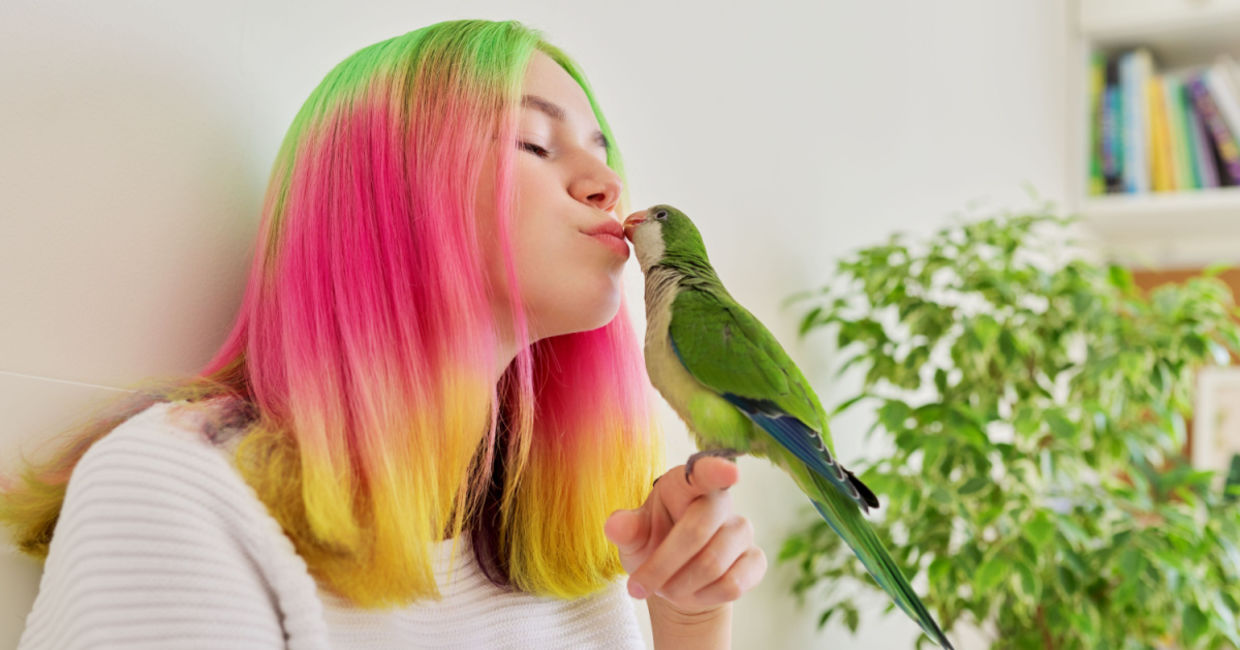 A teen with her pet bird.