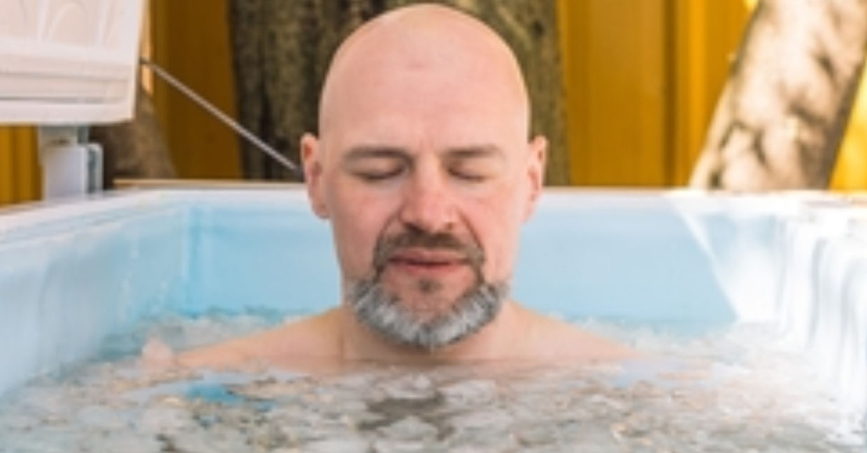 Man taking an ice bath.