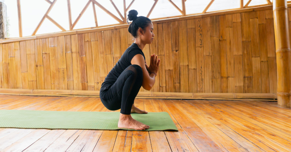 Women in the malasana yoga pose.