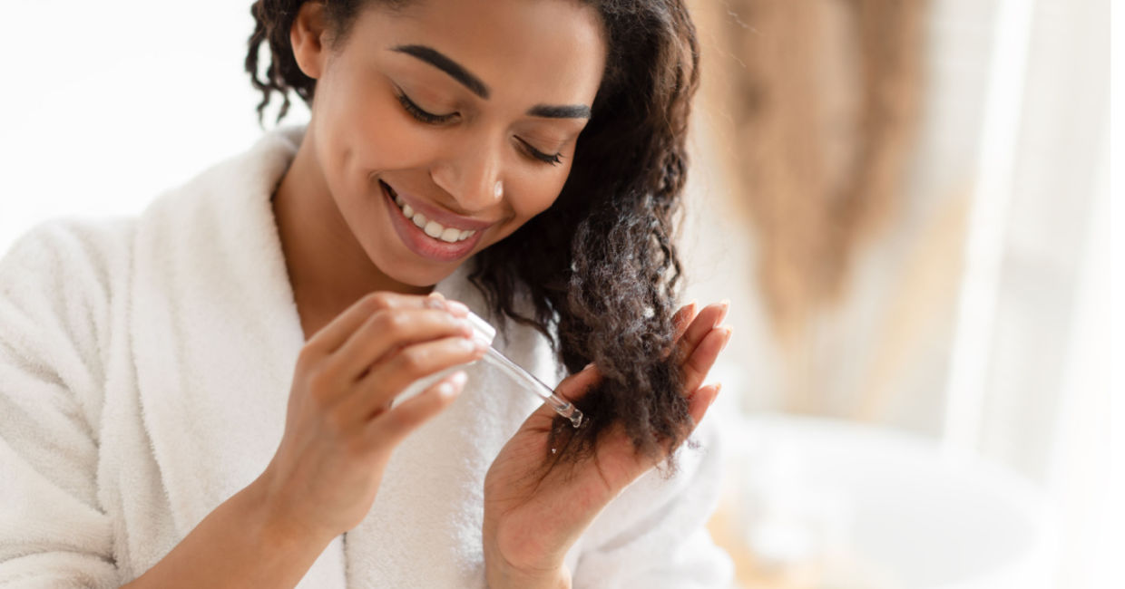 Woman using an organic oil in her hair.