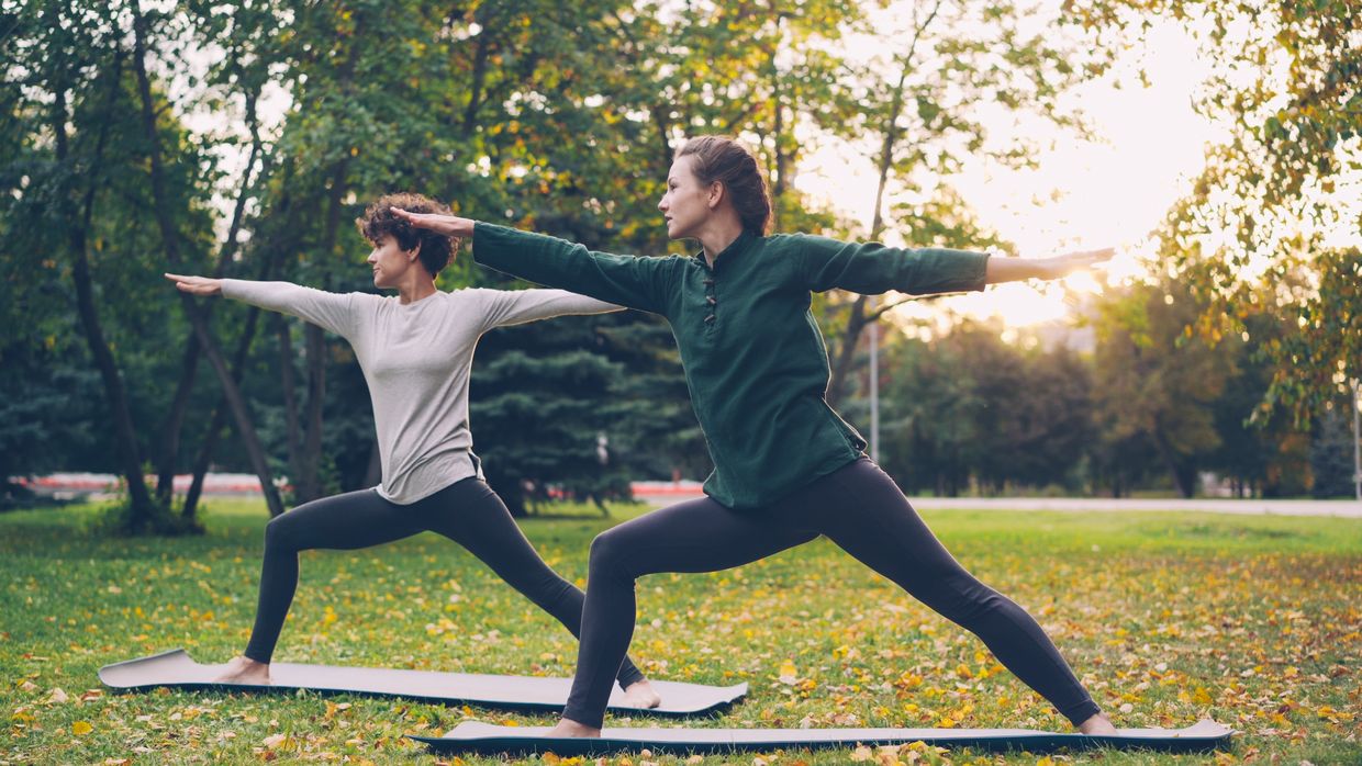 Women in the half moon yoga pose.