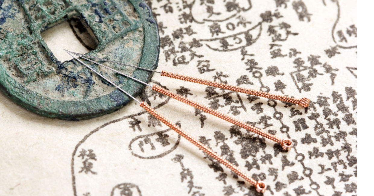 Acupuncture needles and text.