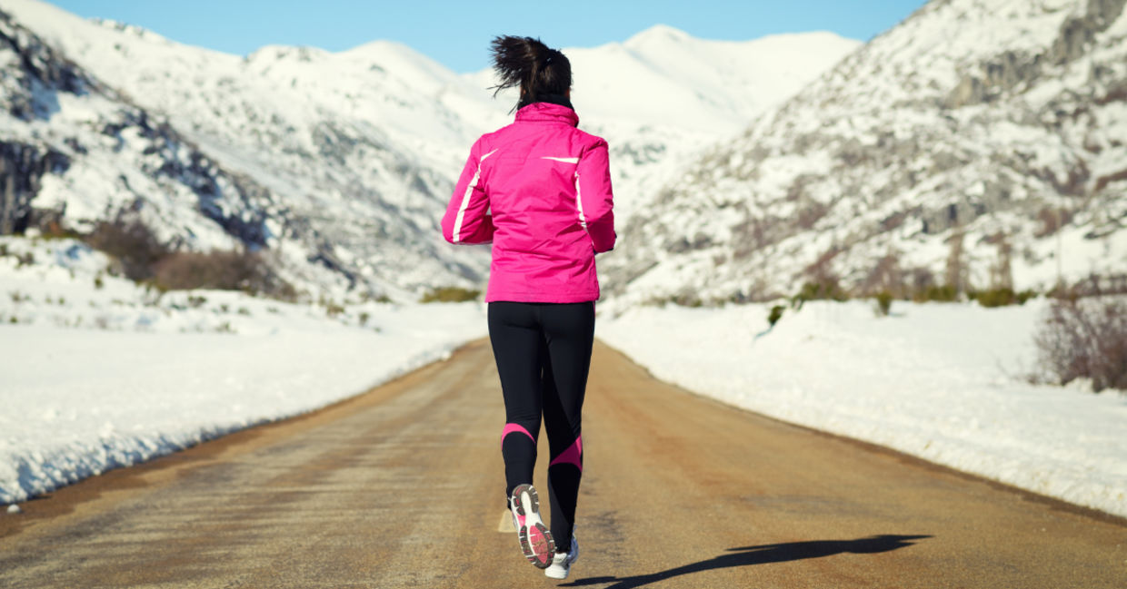 Motivated woman running during the winter.