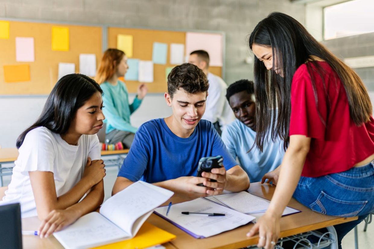 Teens using cellphones during school.