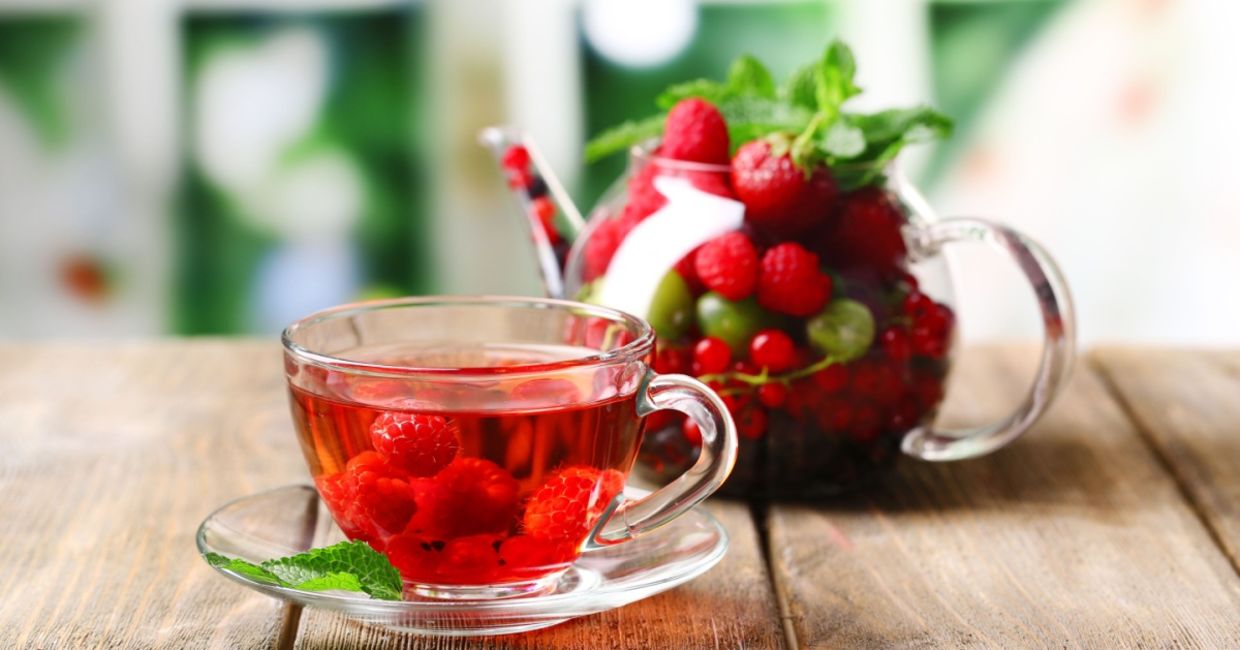 A cup of tea with berries.