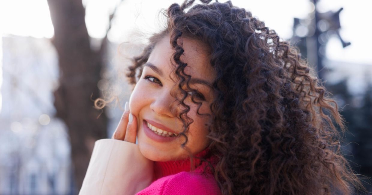 Smiling, young Gen Z woman.