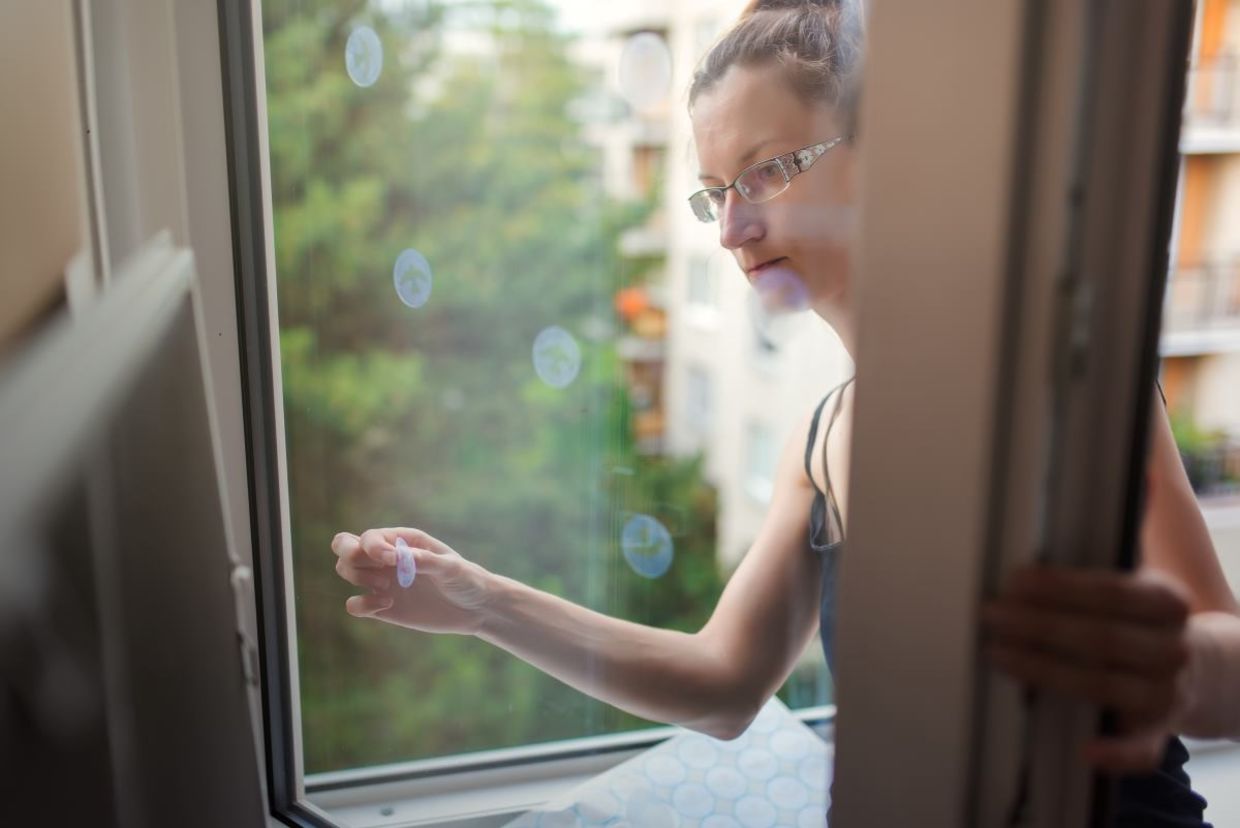 Placing reflective decals on a window.