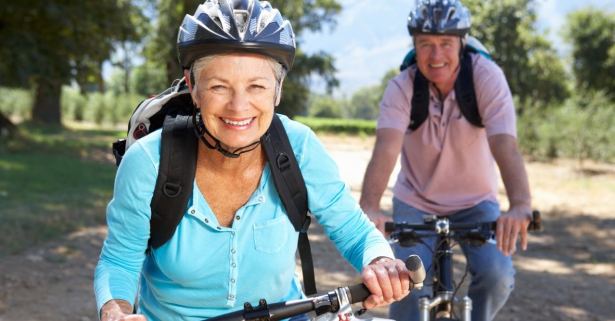 Two healthy seniors riding bikes.