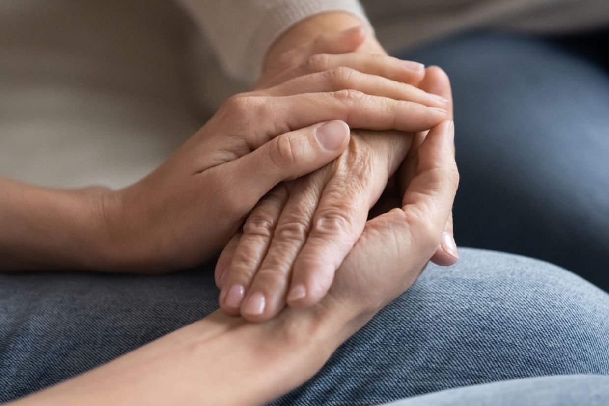Two people hold hands.