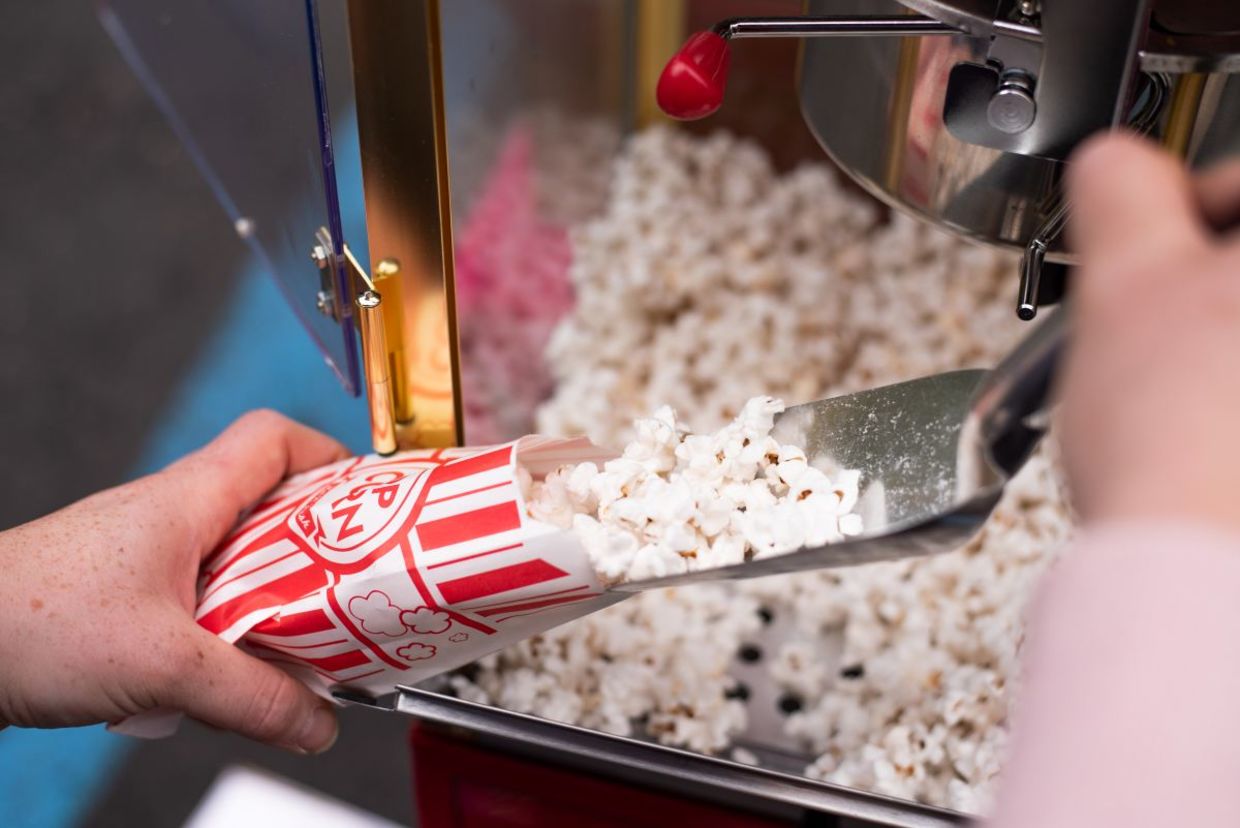 Old fashioned popcorn makers are a hit at a party.