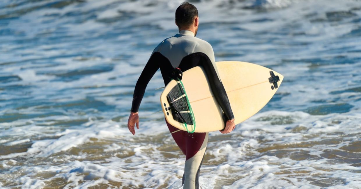 Surfer wearing a wetsuit.