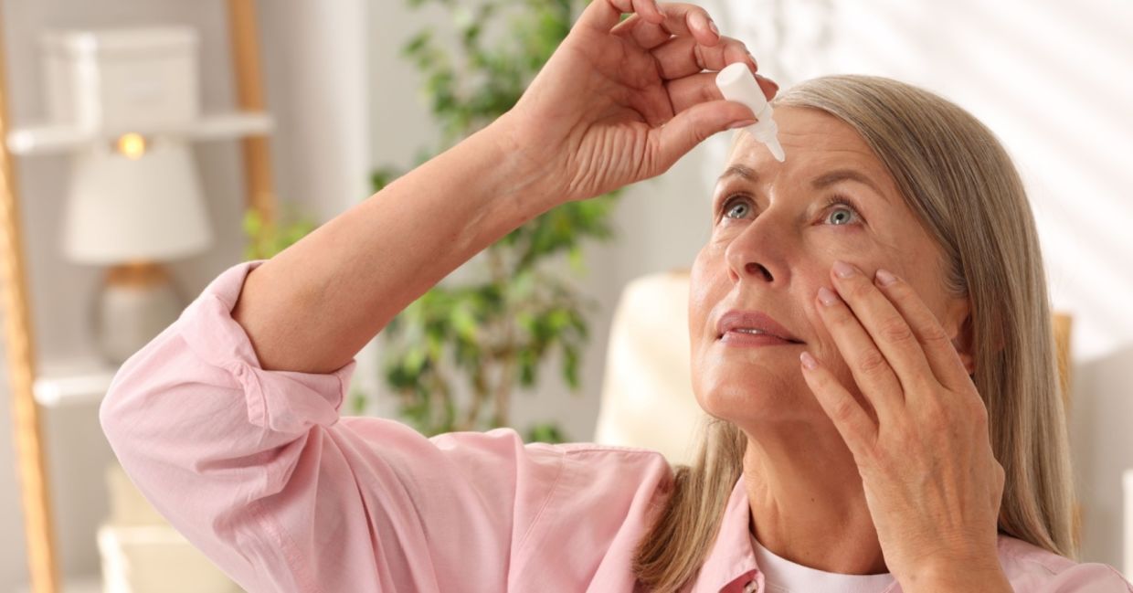 A senior woman using eye drops to improve her vision.