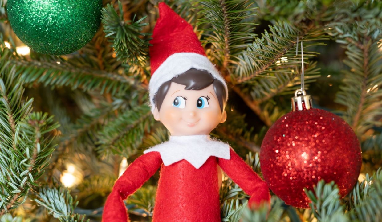 Hiding the Elf on the Shelf on a Christmas tree.