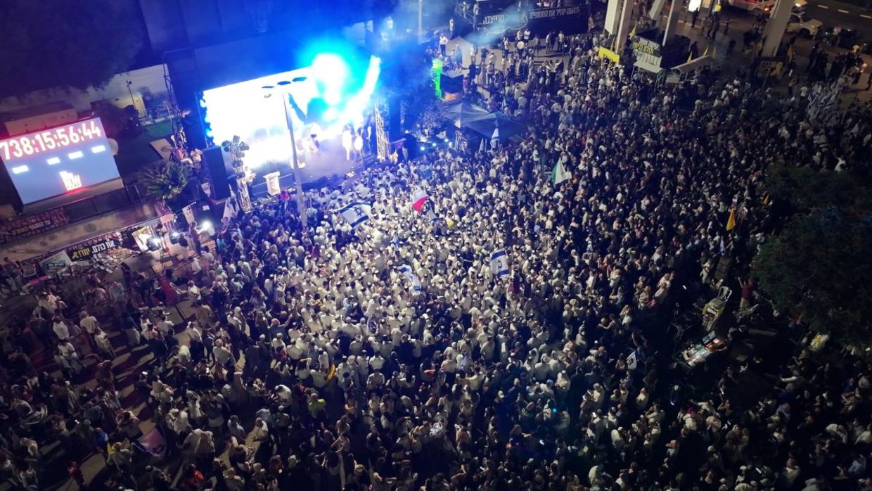 Aerial night view of thousands gathered in Tel Aviv’s Hostages Square.