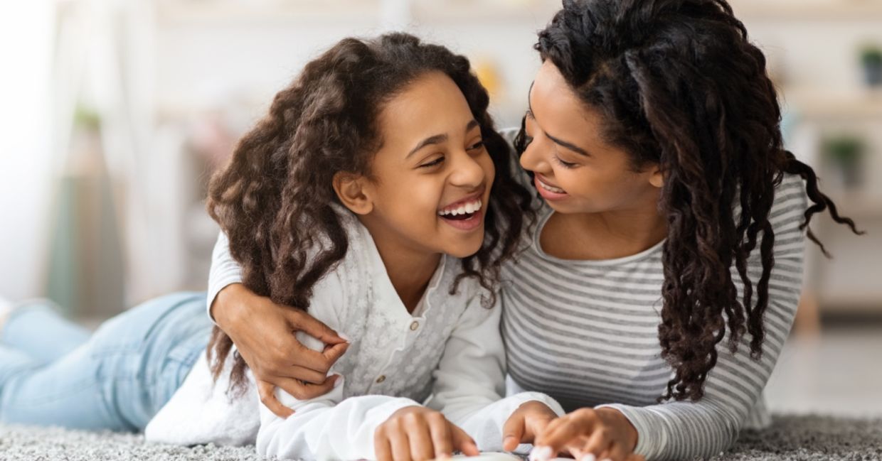 Mother and daughter reading about Black History.