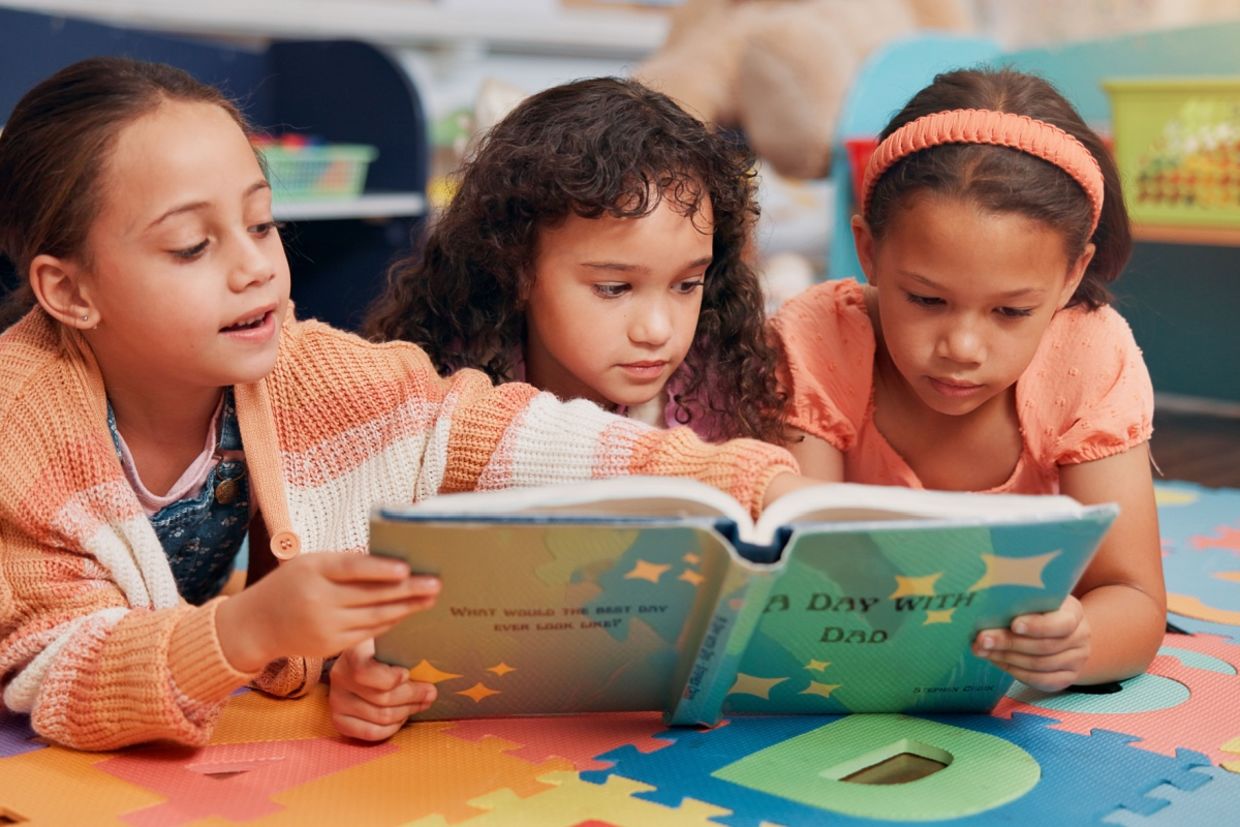 Girls reading books together.