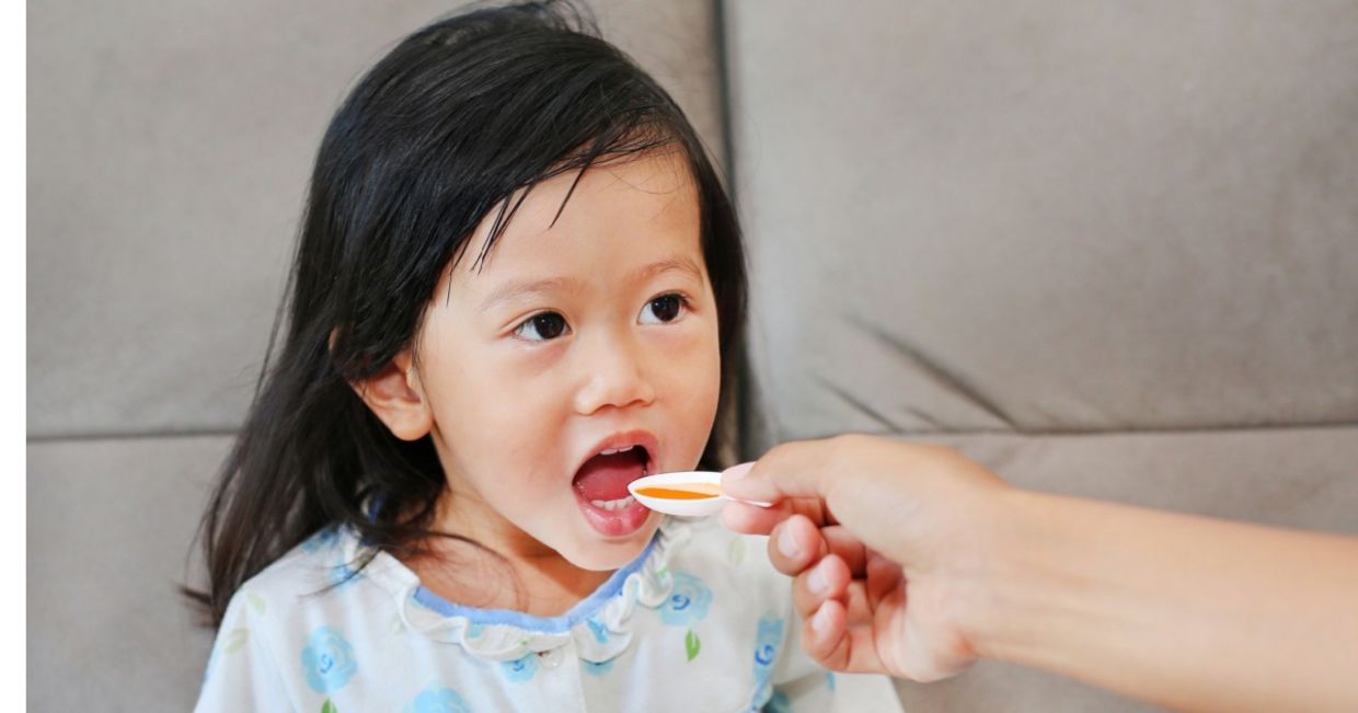 Girl taking her medicine.