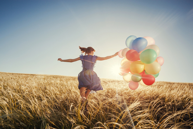 Happy Happy woman running with ballons
