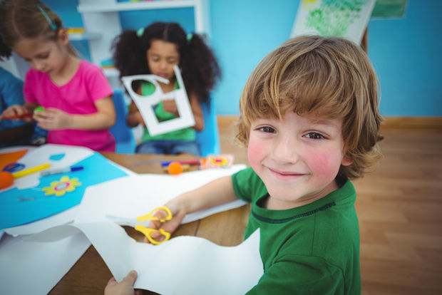A happy child doing arts and crafts