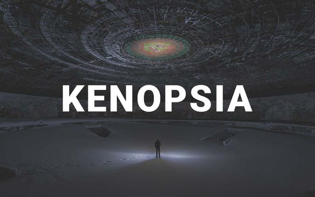 photo A solitary figure standing in the center of a vast, abandoned brutalist structure with an intricate circular domed ceiling, illuminated by a single beam of light, with the word 'KENOPSIA' displayed in large white capital letters across the center of the image.