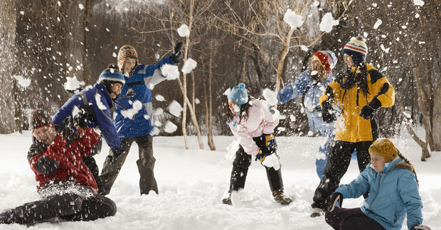 photo Group snowball fight in winter forest.