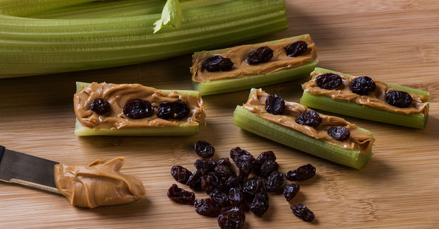 photo Celery sticks with peanut butter and raisins.