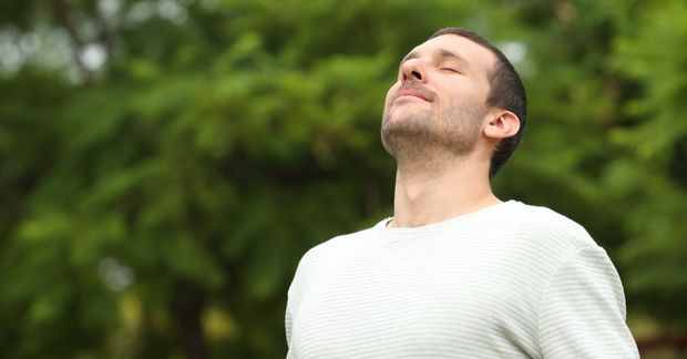 Man Man doing breathing exercise.