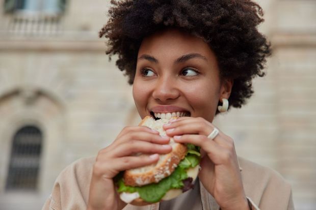 woman woman eating a sandwich